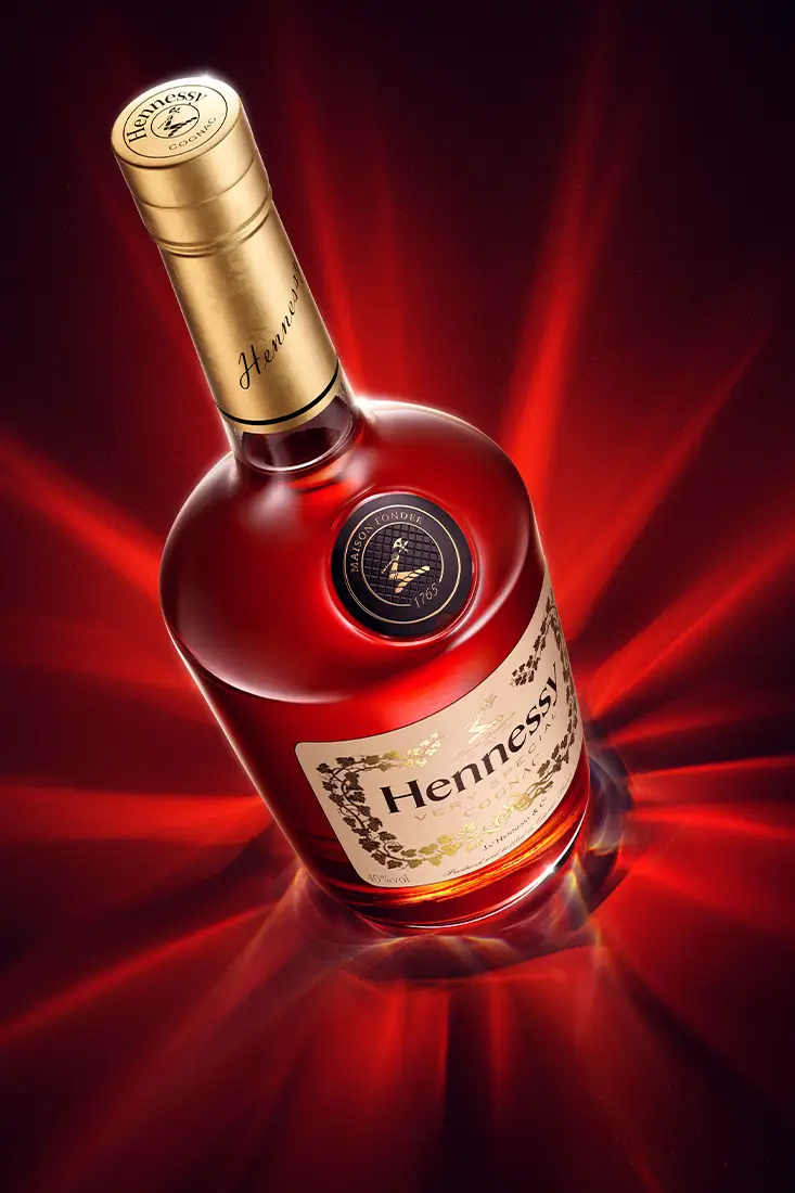 A highly refined 3d cgi visualization of a red cognac bottle surrounded by surreal caustic effects. High quality advertising rendering in CGI