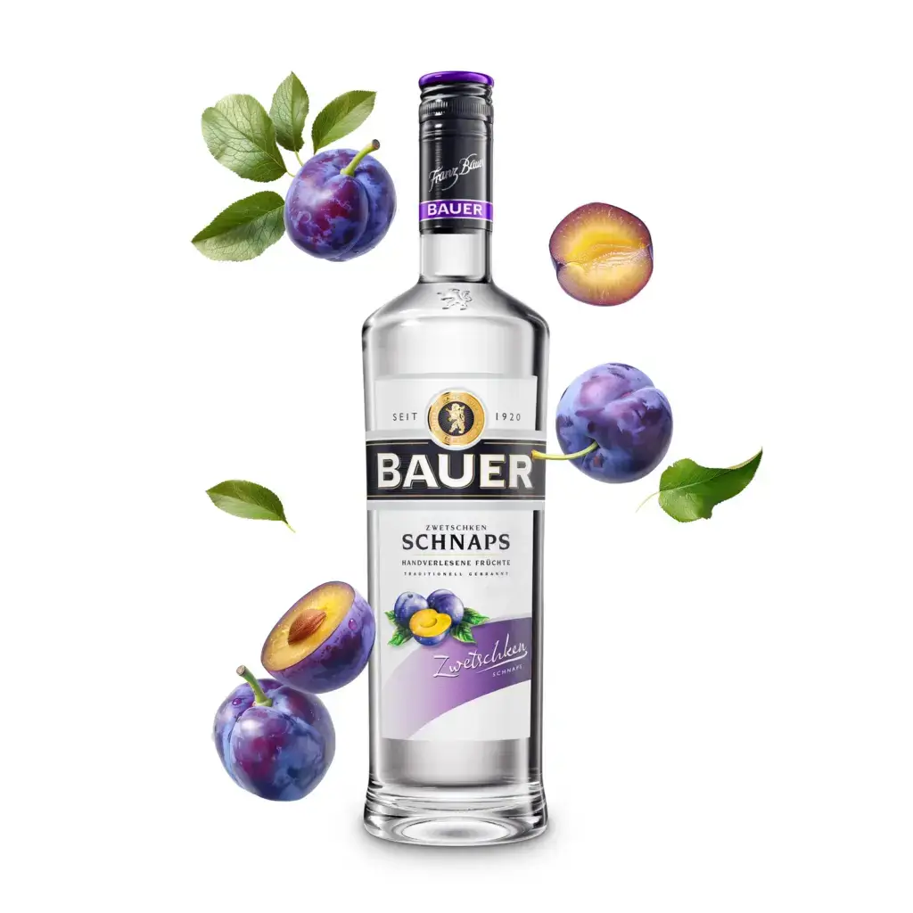 Bauer Zwetschken Schnaps bottle with floating plums and leaves — clean product photography for Amazon ecommerce listing