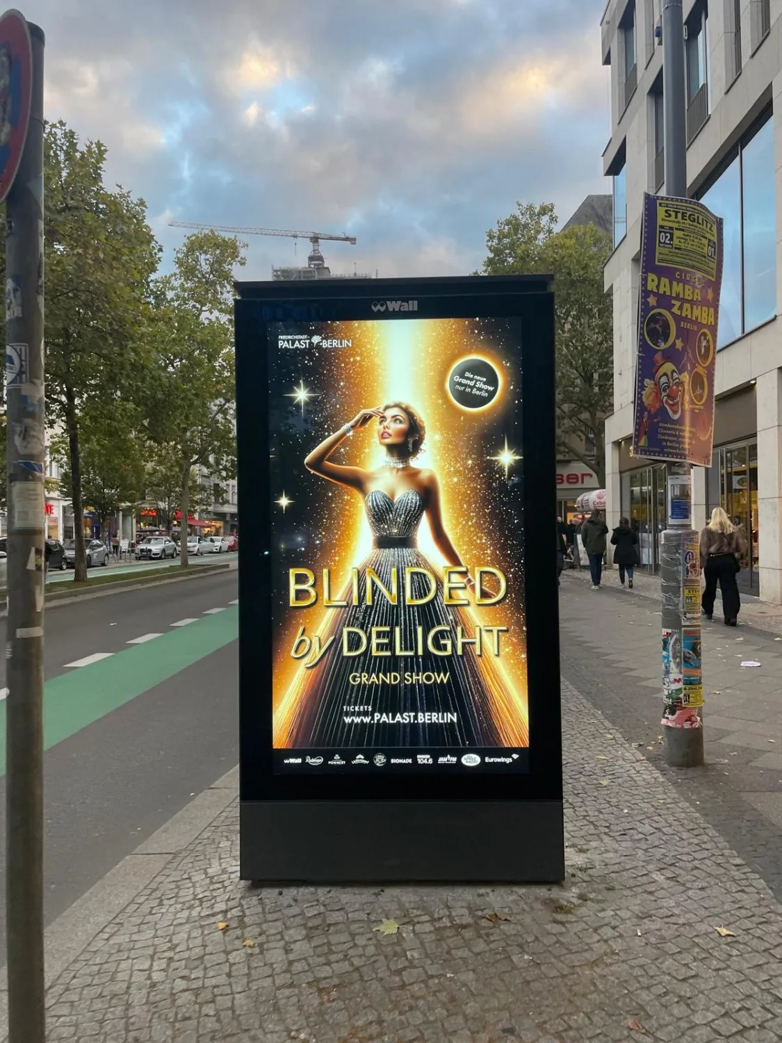 Friedrichstadt-Palast campaign poster at Berlin bus stop showing AI-generated artwork
